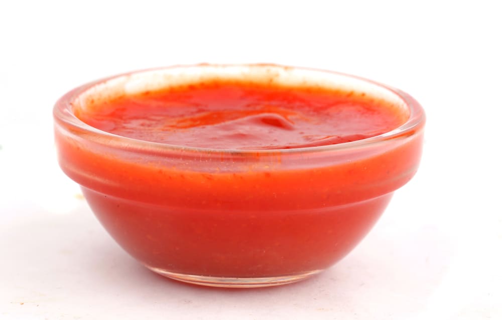 A Bowl Of Open Sriracha Sauce