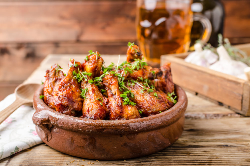 Grilled chicken wings served with beer